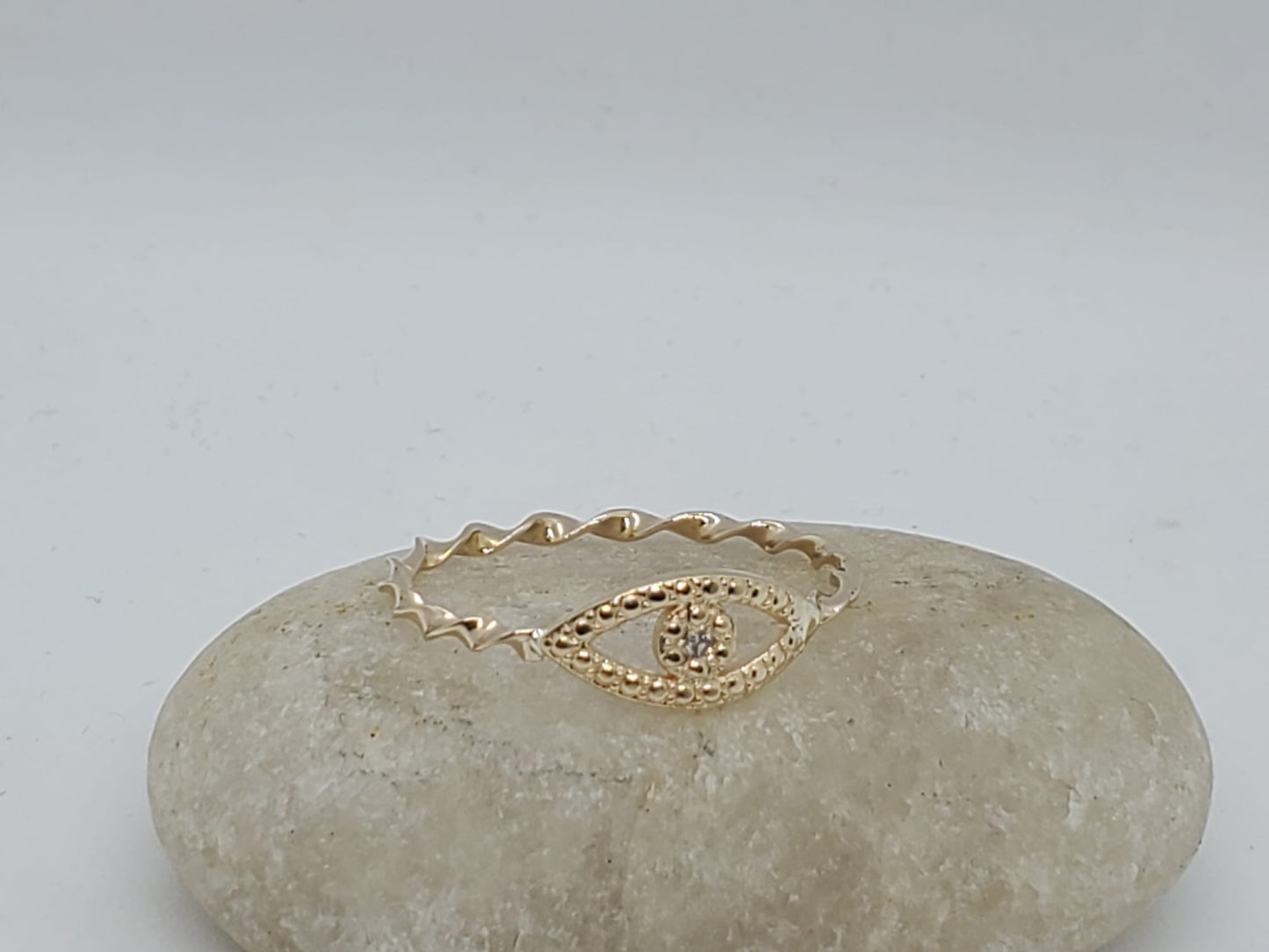 14k twist style yellow band ring with a lucky eye design, 1 Diamond 1.5mm